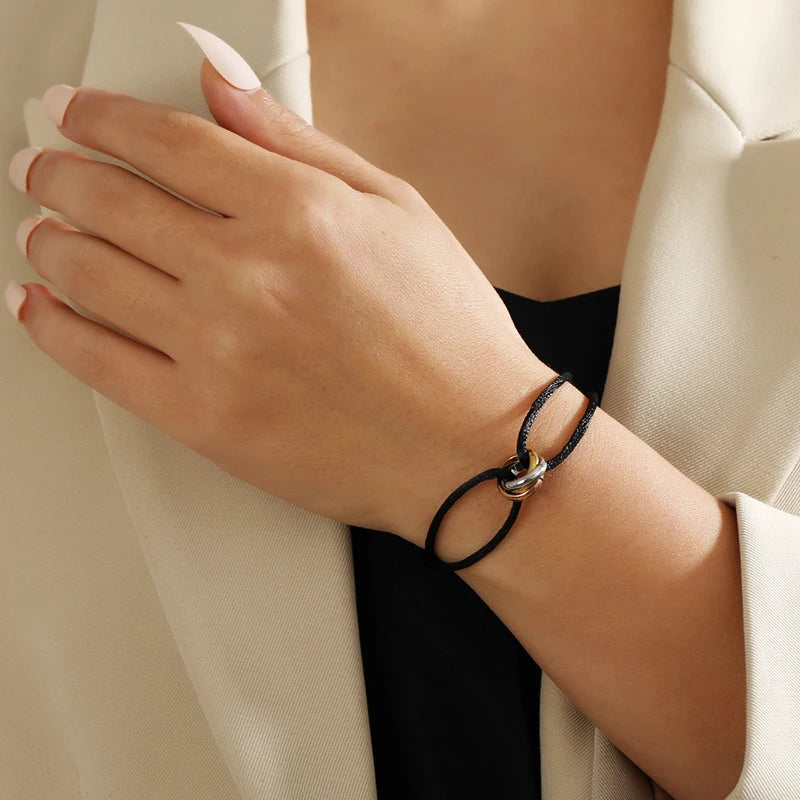 Unisex jewelry bracelet with three metal round circles and adjustable rope design, stylish accessory for men and women.