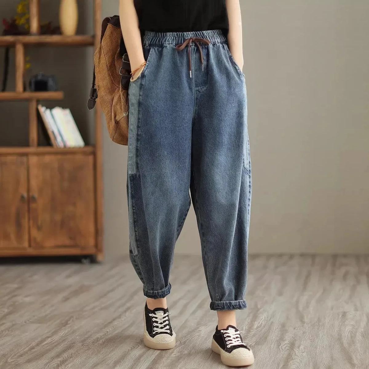 Women's denim harem pants by Jelieora Venture featuring relaxed fit and stylish design, shown on a model.