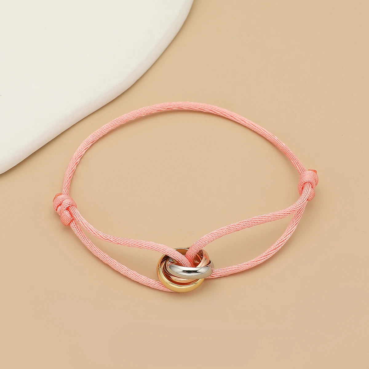 Unisex Jelieora Venture bracelet with three metal circles on adjustable rope, stylish jewelry for men and women.
