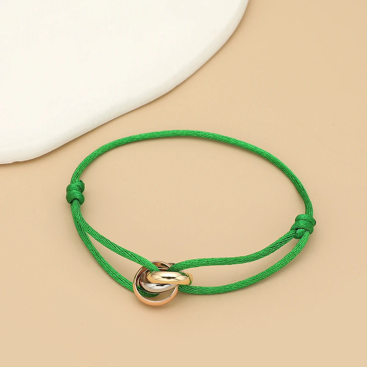 Unisex bracelet with three metal round circles and adjustable rope design, stylish jewelry accessory by Jelieora Venture.