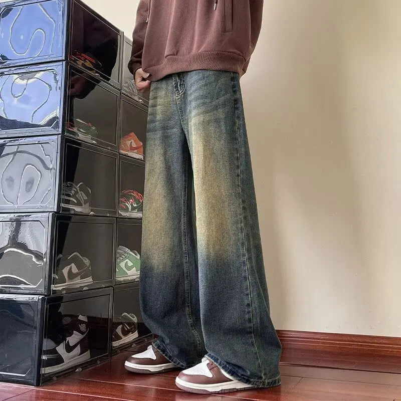 Men's distressed wide-leg jeans by Jelieora Venture, featuring a relaxed fit with ripped details and faded denim finish.