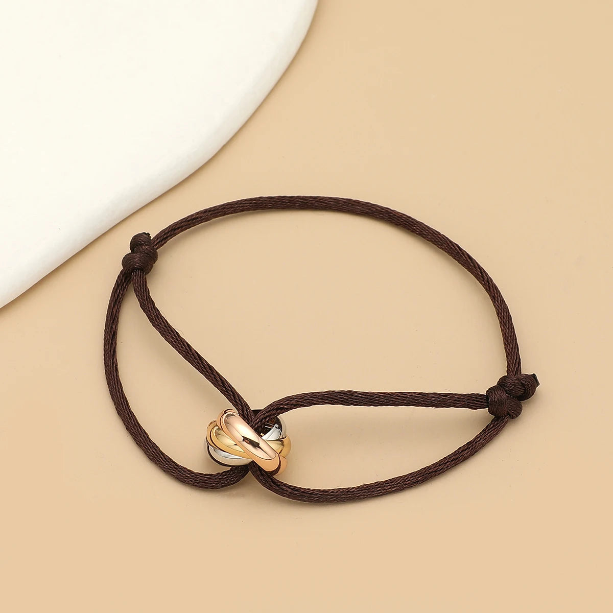 Unisex Jelieora Venture bracelet with three metal round circles on adjustable rope, stylish jewelry accessory for men and women