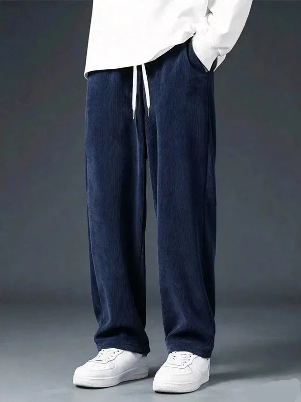 Men's straight leg corduroy trousers by Jelieora Venture showing navy blue fabric and classic fit on a model.