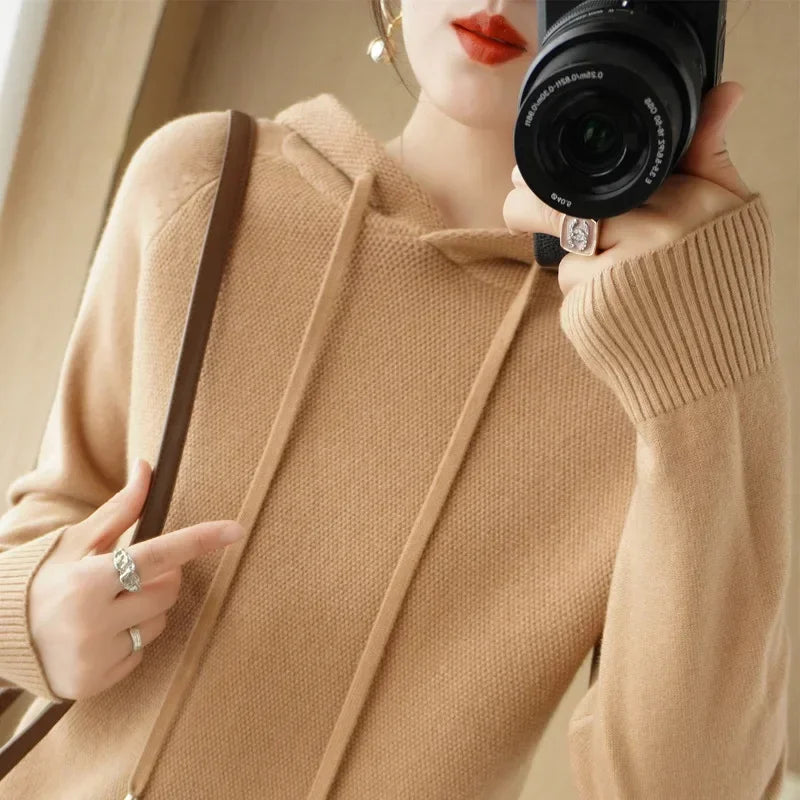 Women's knitted hoodie jumper by Jelieora Venture featuring a cozy, soft-knit fabric and a relaxed fit with a hood and long sleeves.