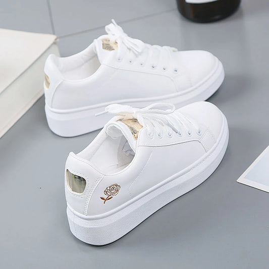 Women's embroidered floral lace-up trainers by Jelieora Venture, featuring colorful floral embroidery and white rubber soles.