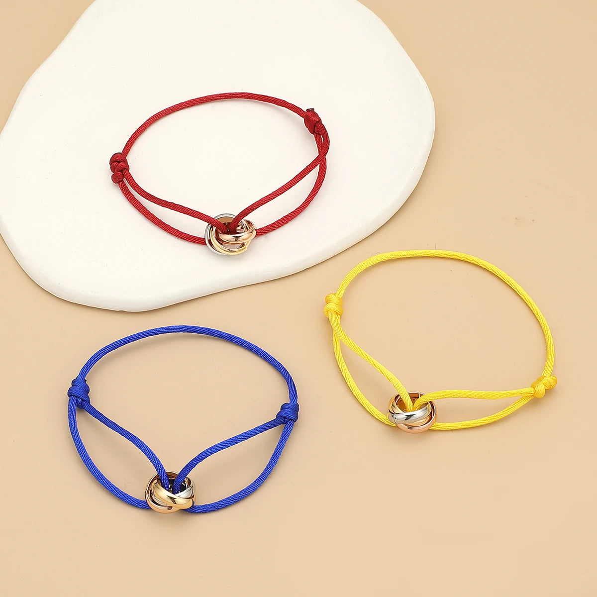 Unisex bracelet by Jelieora Venture featuring three metal round circles on adjustable rope jewelry for men and women.