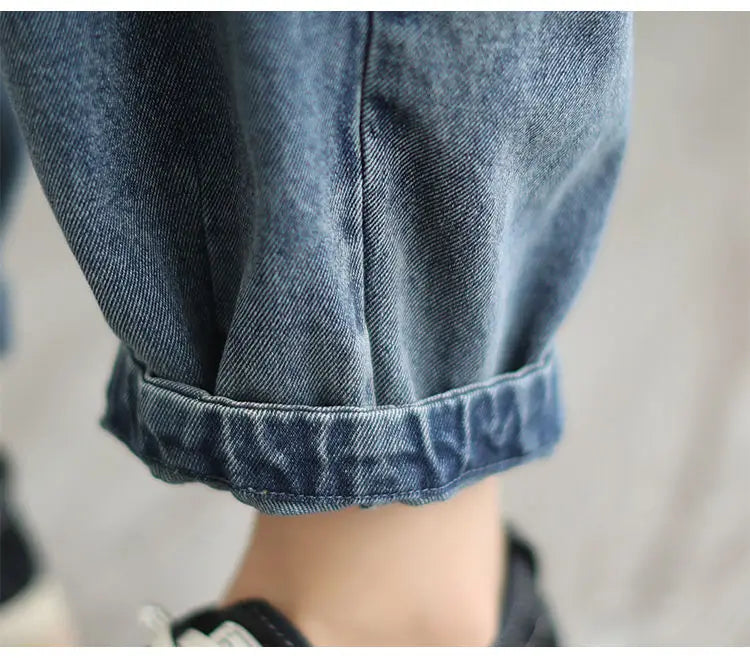 Women's denim harem pants by Jelieora Venture featuring a relaxed fit and stylish design on a plain background.
