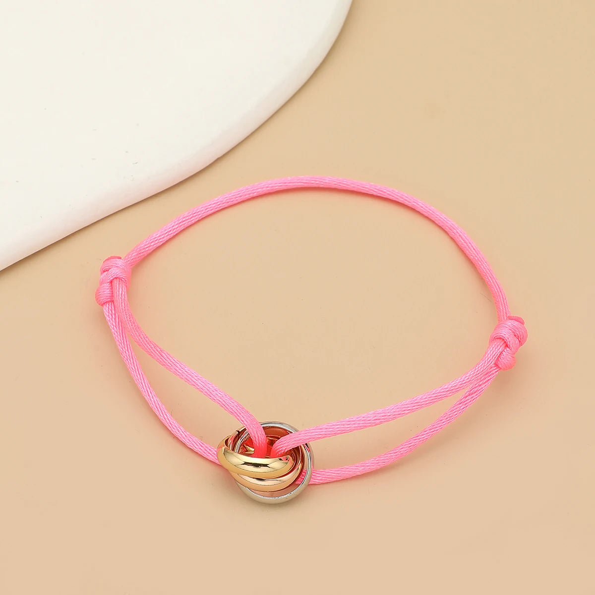 Unisex bracelet featuring three metal round circles on adjustable rope, jewelry accessory for men and women.