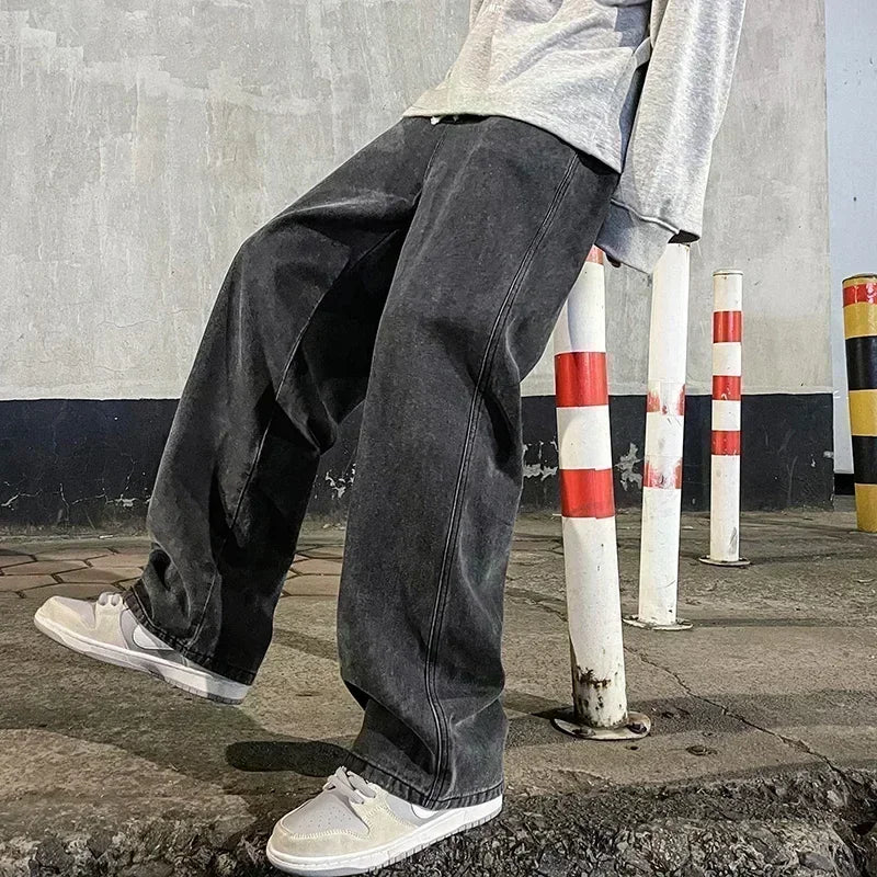 Men's wide-leg streetwear jeans by Jelieora Venture, showing the relaxed fit, faded denim, and front pockets.