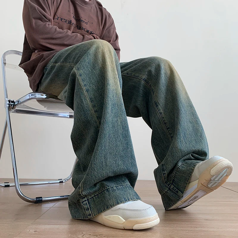 Men's distressed wide-leg baggy jeans by Jelieora Venture featuring a relaxed fit and ripped details in a casual denim style.