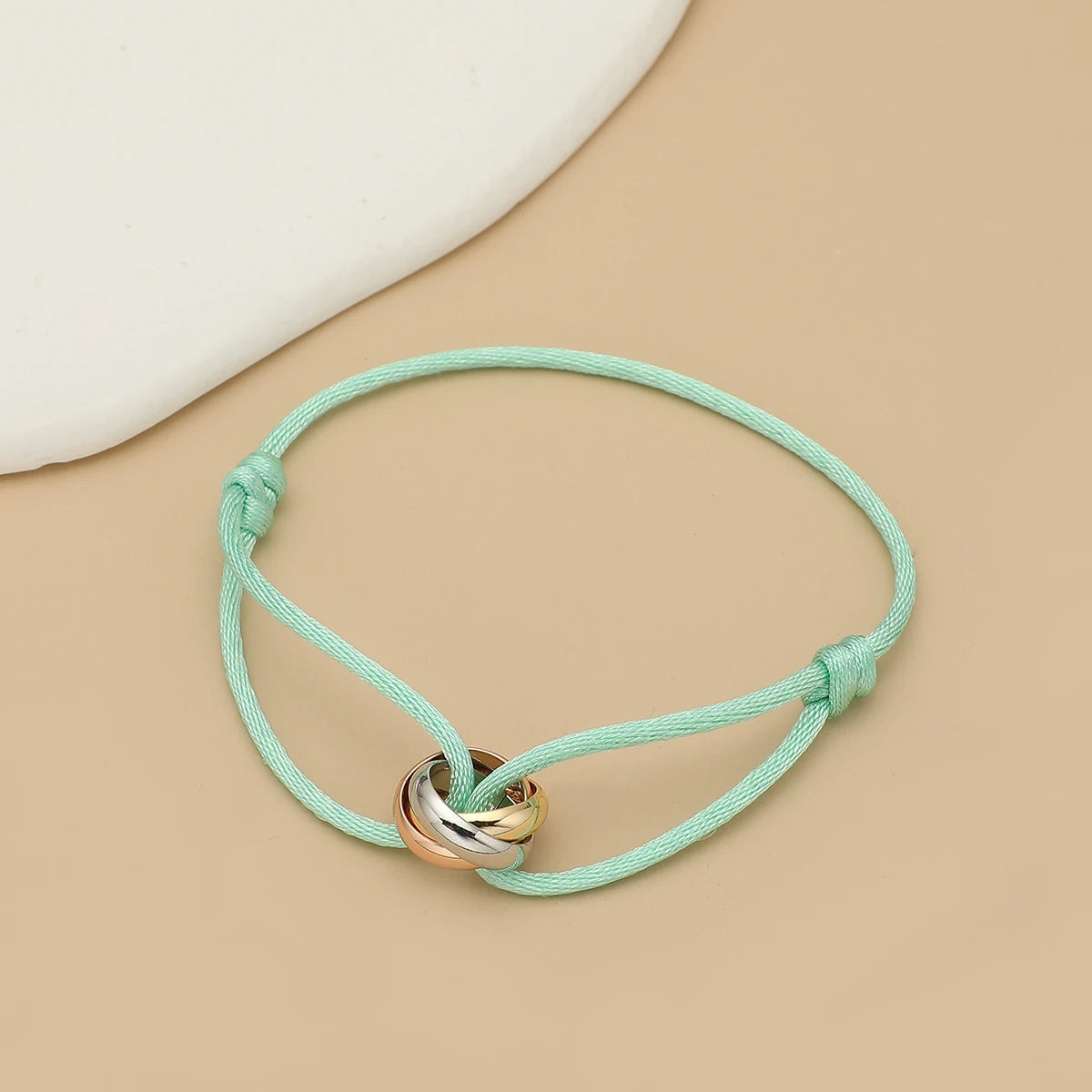 Simple Jelieora Venture unisex bracelet with three metal round circles, adjustable rope jewelry for men and women.