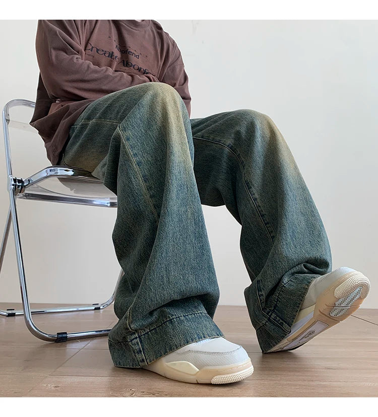 Men's distressed wide-leg baggy jeans by Jelieora Venture, featuring a relaxed fit and rugged, worn-in look in dark denim.