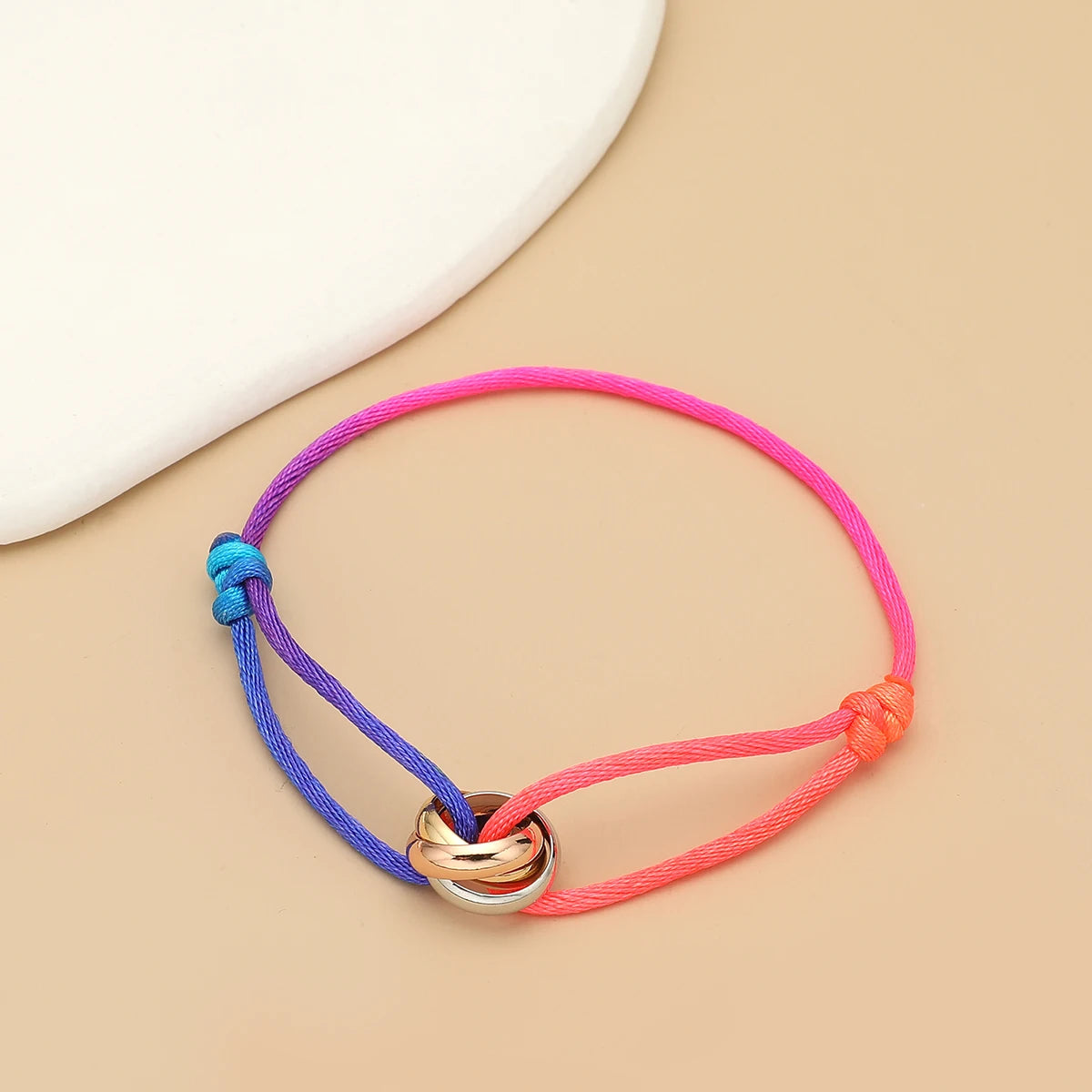 Unisex jewelry bracelet with three metal round circles on adjustable rope, stylish accessory for men and women by Jelieora Venture.