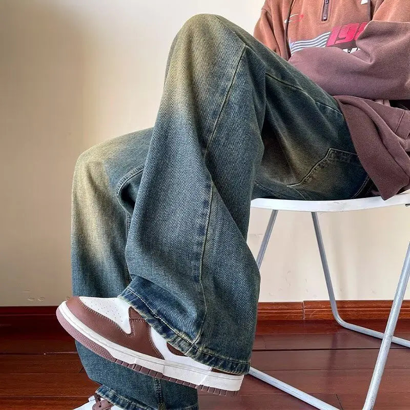 Men's distressed wide leg jeans by Jelieora Venture featuring a relaxed fit, ripped details, and a casual denim style.