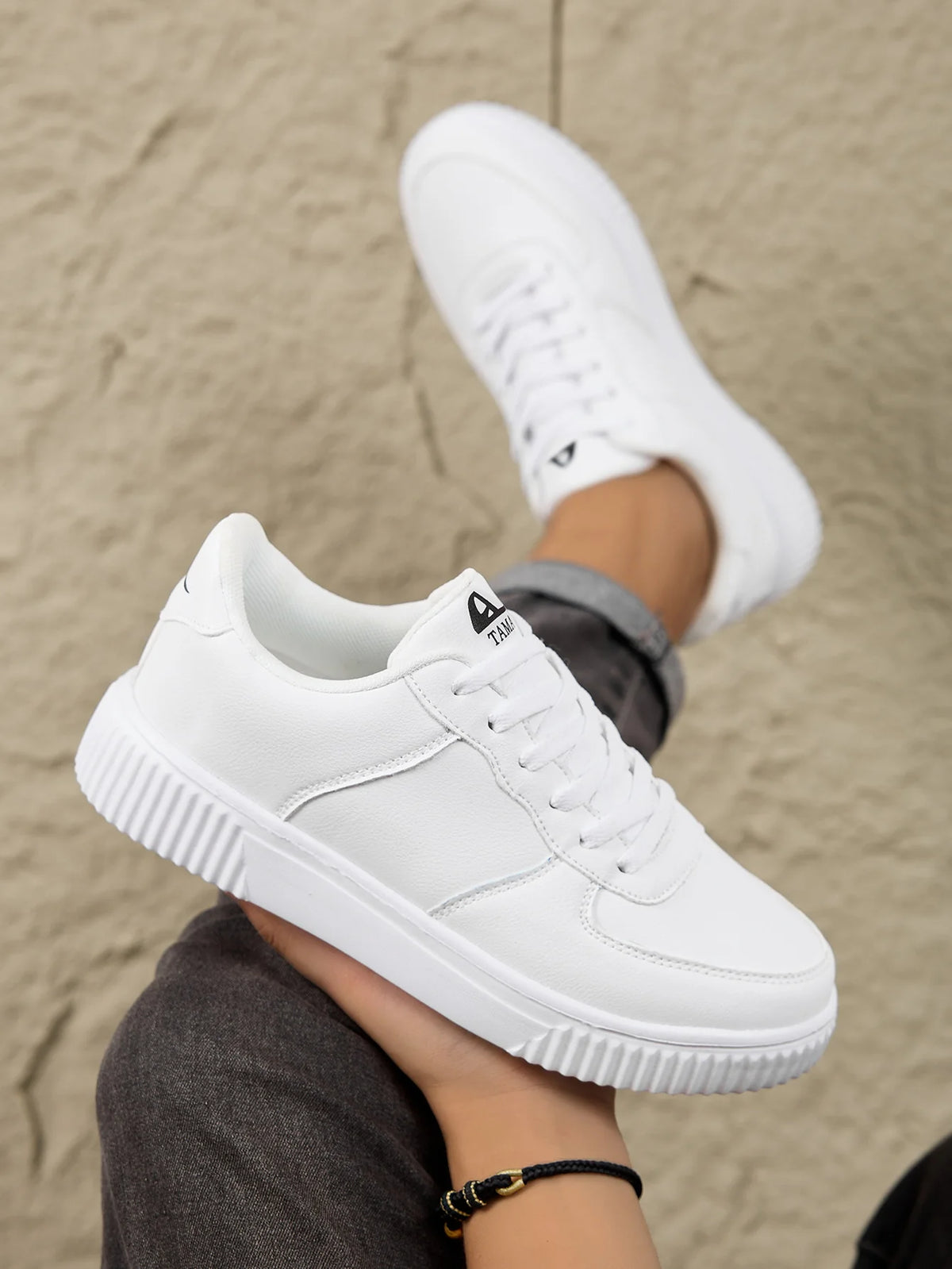 Men's white leather sneakers by Jelieora Venture, featuring a sleek design and white laces, on a neutral background.