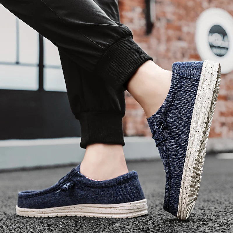Men's denim canvas trainers by Jelieora Venture featuring casual design, white rubber soles, and blue denim fabric.