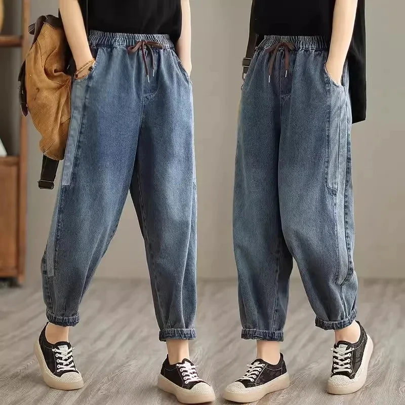 Women's denim harem pants by Jelieora Venture featuring a relaxed fit, elastic waistband, and stylish tapered legs.
