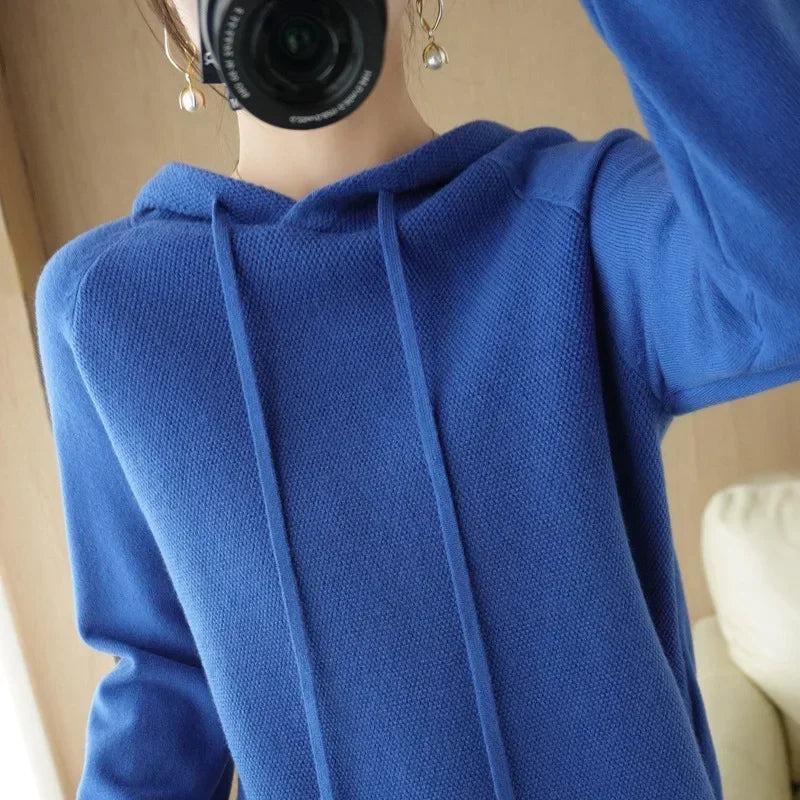 Women's knitted hoodie jumper by Jelieora Venture, featuring a cozy design with a front pocket and ribbed cuffs.