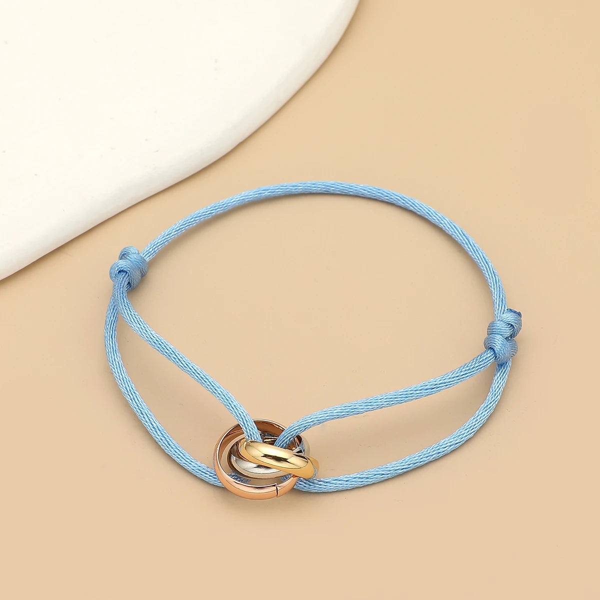 Unisex jewelry bracelet with three metal round circles on adjustable rope, stylish accessory for men and women by Jelieora Venture.