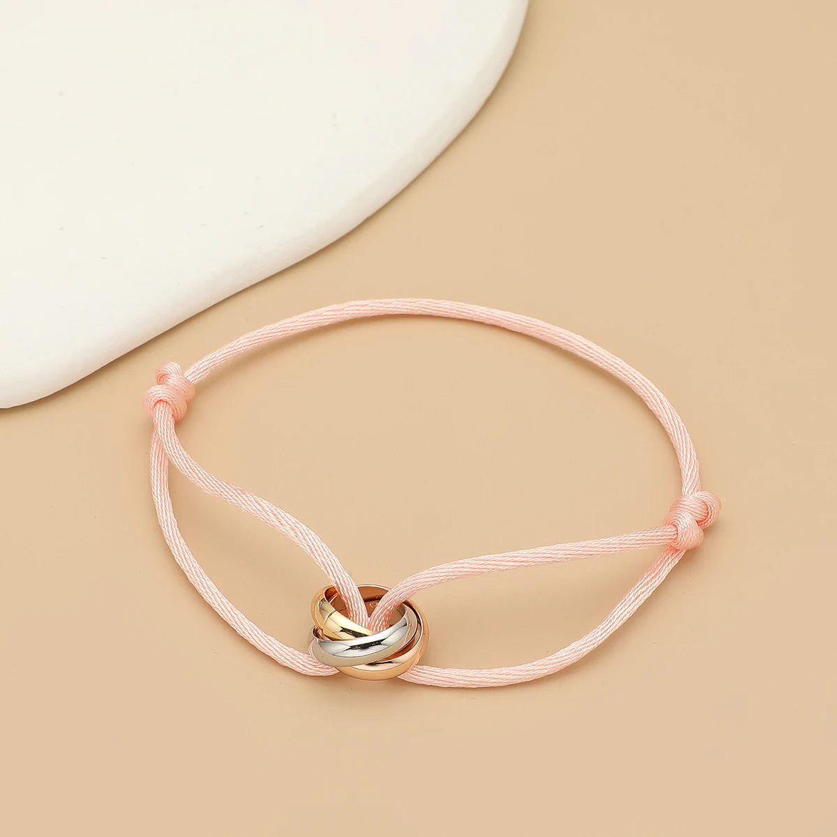 Simple fashion unisex bracelet by Jelieora Venture featuring three metal round circle charms on a adjustable rope band.