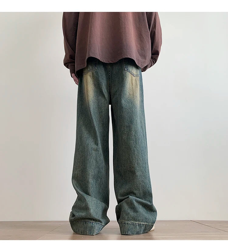 Men's distressed wide-leg baggy jeans by Jelieora Venture, showcasing faded denim, relaxed fit, and distressed details.