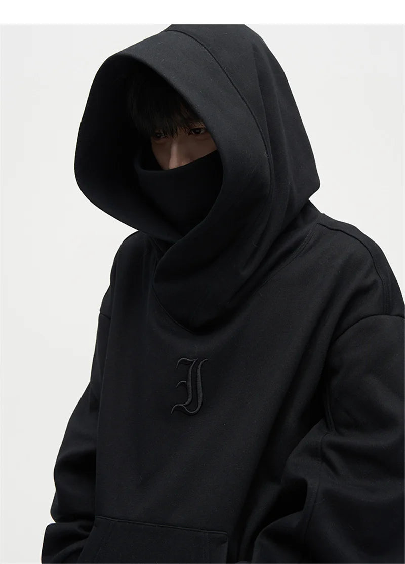 Men's black turtleneck hoodie by Jelieora Venture, featuring a cozy fit and front kangaroo pocket, displayed on a neutral background.