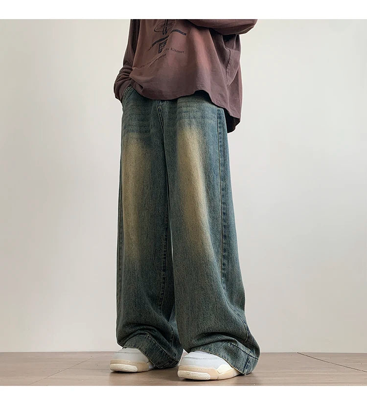 Men's distressed wide-leg baggy jeans by Jelieora Venture, showing faded denim with ripped details and relaxed fit.