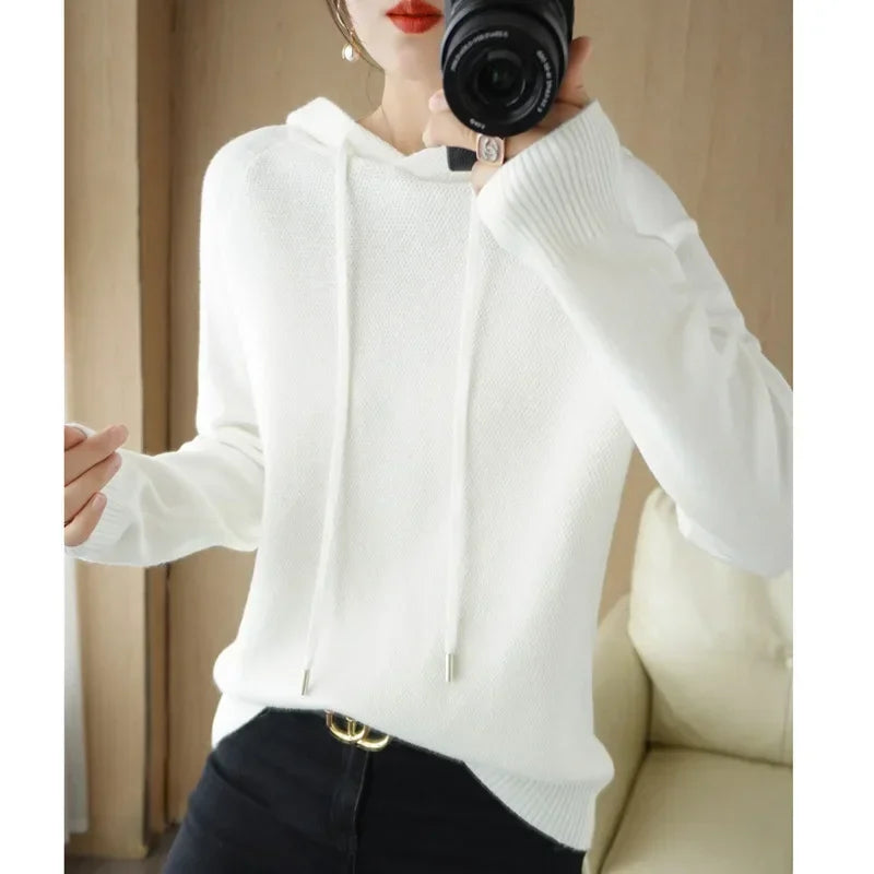Women's knitted hoodie jumper by Jelieora Venture, featuring a cozy, stylish design with a front pocket and drawstring hood.
