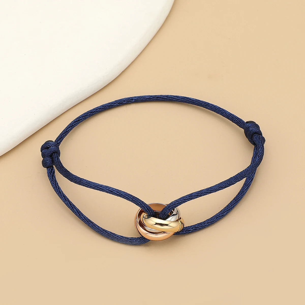 Unisex Jelieora Venture bracelet with three metal round circles on adjustable rope band, stylish jewelry accessory for men and women.