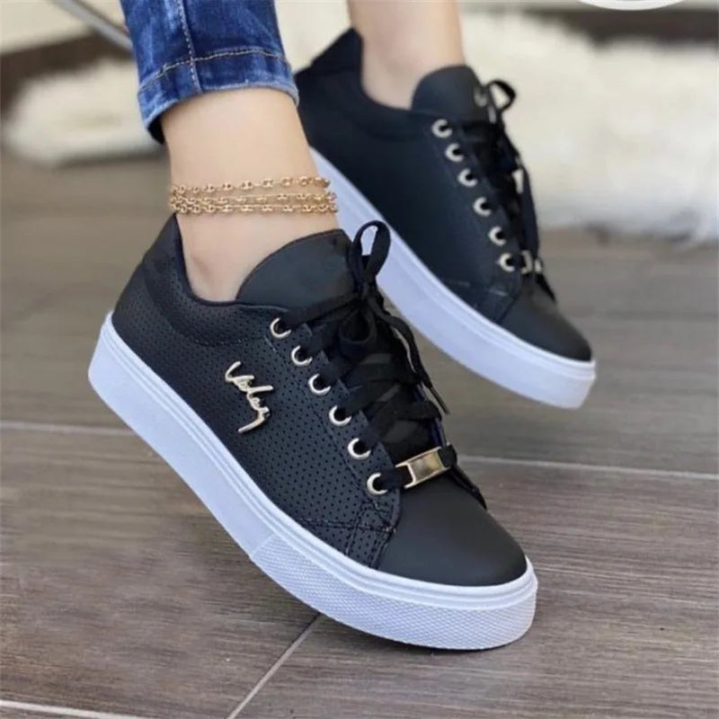 Women's lace-up vulcanized flat sneakers by Jelieora Venture, showcasing classic sneaker design with lace-up front and flat sole.
